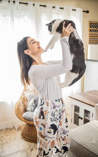 Thumbnail for Image of female model holding a cat in the air and wearing Life Is Better With A Cat pajama lounge pants