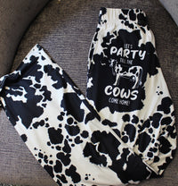 Thumbnail for Party 'Till The Cows Come Home pajama lounge pants laid out on a gray chair