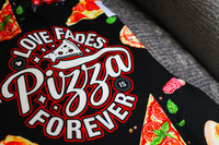 Thumbnail for Pizza Is Forever pajama lounge pants laid out on gray chair close up image of text