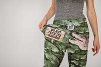 Thumbnail for Cropped close up image of model wearing Do Not Feed The Gators pajama lounge pants front view showing off text (white background)