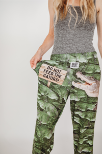 Thumbnail for Image of model wearing Do Not Feed The Gators pajama lounge pants front view showing off text (white background)