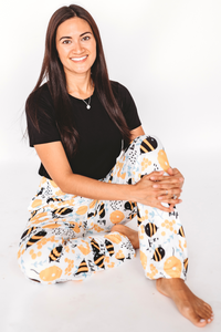 Thumbnail for Image of model sitting on the floor wearing Honey Bee pajama lounge pants front view (white background)