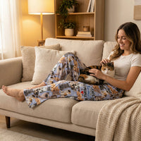 Thumbnail for Female model relaxing on a modern couch wearing Cats Favorite People Lounge Pants, petting a cat, in a cozy living room setting.