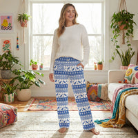Thumbnail for Model wearing I'd Rather Be Skiing lounge pants in a colorful living room with plants and playful decor, highlighting the Nordic-inspired winter pattern.