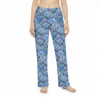 Thumbnail for Young woman relaxing on sofa in blue hydrangea lounge pants a cozy living room scene.