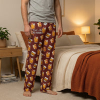 Thumbnail for Female model standing in a warm-toned bedroom wearing all-over printed old fashioned lounge pants with cocktails and cheeky phrase, emphasizing comfort and style.