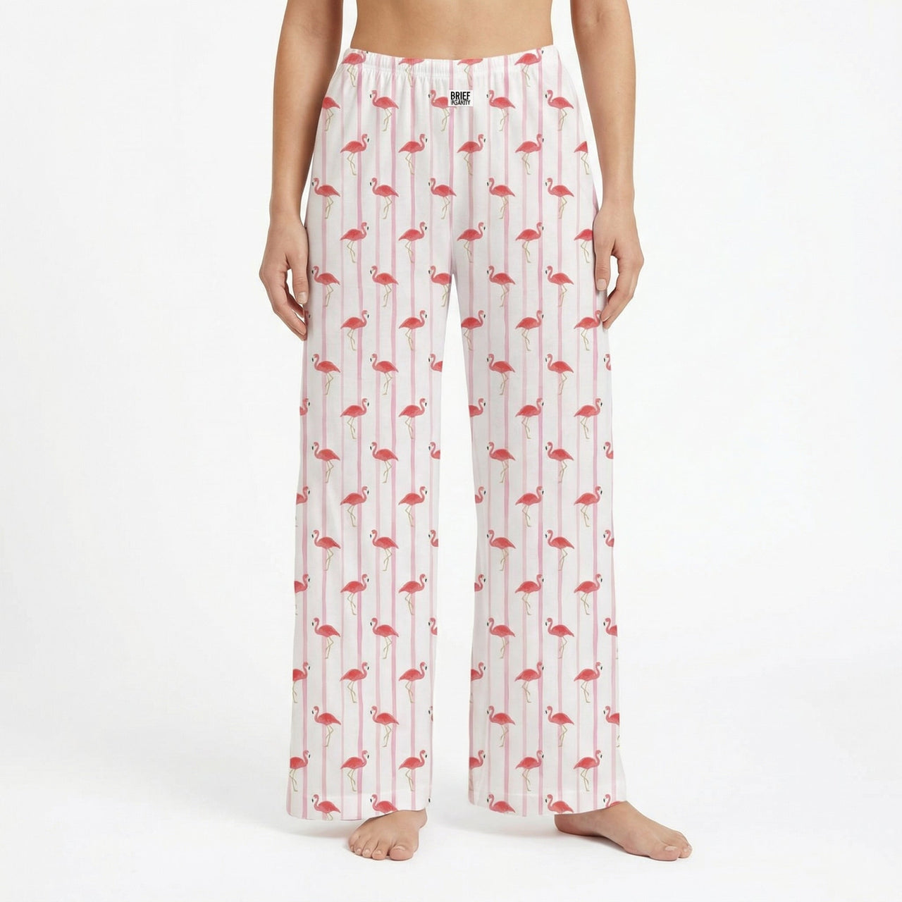 Model wearing flamingo striped lounge pants with pink flamingos and white stripes, against a white background, showcasing the product's design and fit.