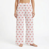Thumbnail for Model wearing flamingo striped lounge pants with pink flamingos and white stripes, against a white background, showcasing the product's design and fit.