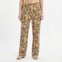 Thumbnail for Model wearing floral Tweety lounge pants featuring vibrant garden-inspired print with Tweety accents, set against a white background for product focus.