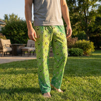 Thumbnail for Male model wearing soccer lounge pants with soccer ball print on green field background in sunny backyard.