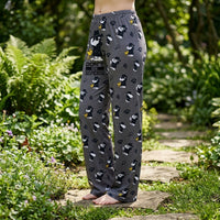 Thumbnail for Female model outdoors in garden wearing Detective Snoopy Lounge Pants, daylight highlighting playful print and fabric micro-texture.