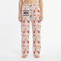 Thumbnail for Young woman in playful living room wearing vibrant dog print lounge pants, surrounded by decor and plants.