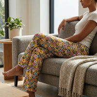 Thumbnail for Seated side profile of Floral Tweety Lounge Pants in a modern living room, emphasizing the sleek silhouette and fabric texture.