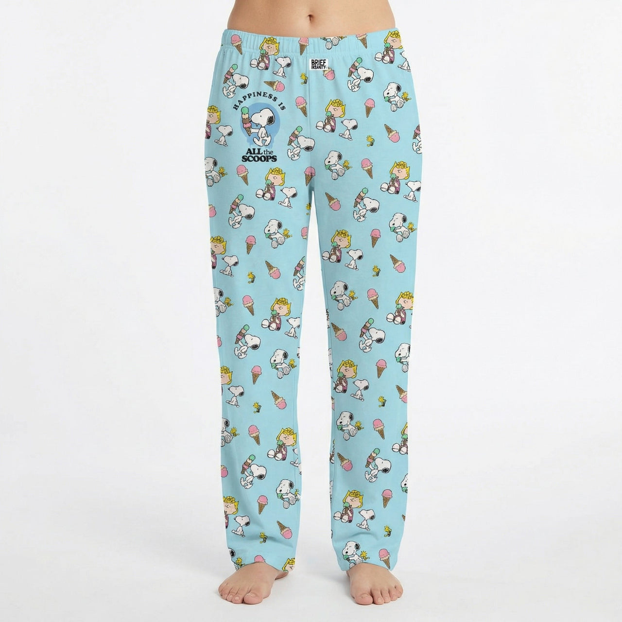 Model wearing Snoopy Ice Cream Lounge Pants with all-over print of Snoopy and friends enjoying ice cream treats, on a white background.