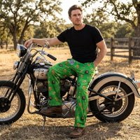 Thumbnail for Full-body shot of male model wearing Willie Nelson lounge pants in a cozy setting, highlighting comfort, vibrant print, and relaxed style.